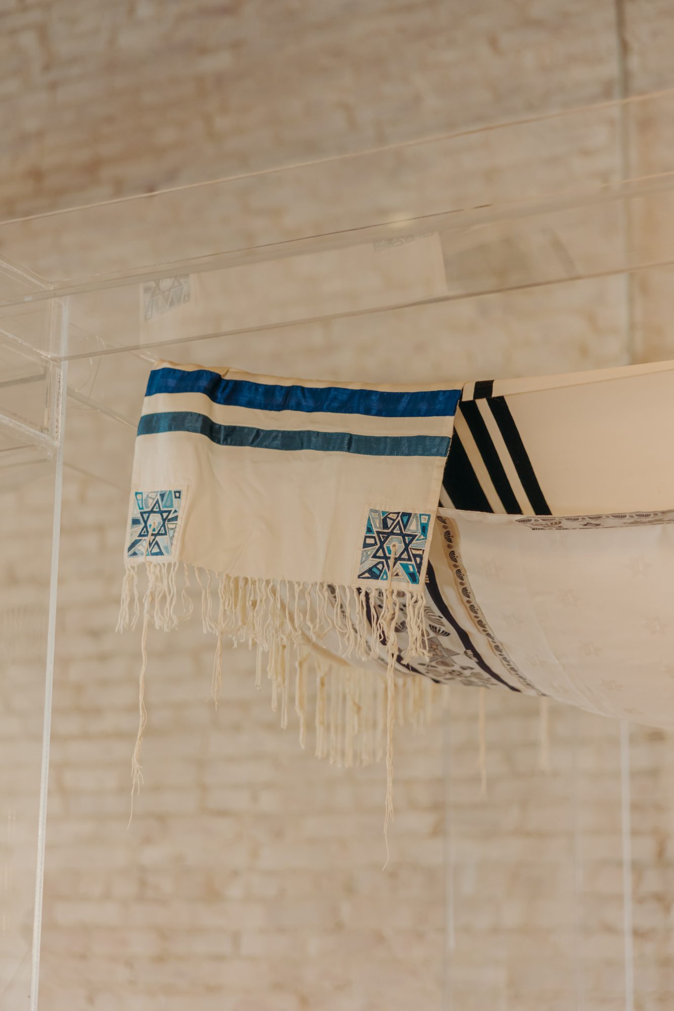 A tallit draped overhead as the chuppah canopy